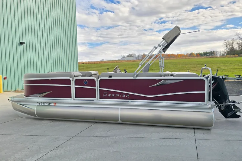 Slide: The Image of 2017 Premier 220 SunSation pontoon boat parked on concrete, under a partly cloudy sky. - 1