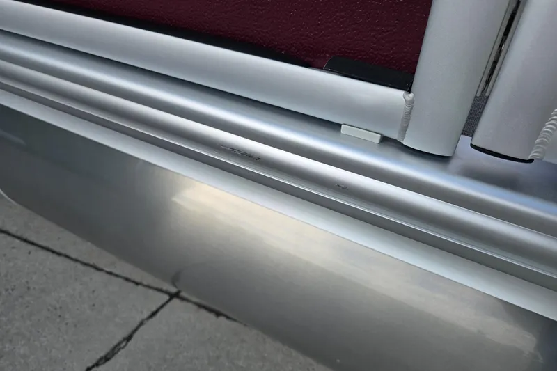 Slide: The Image of Close-up of 2017 Premier 220 SunSation pontoon boat's metallic and maroon exterior detail. - 10