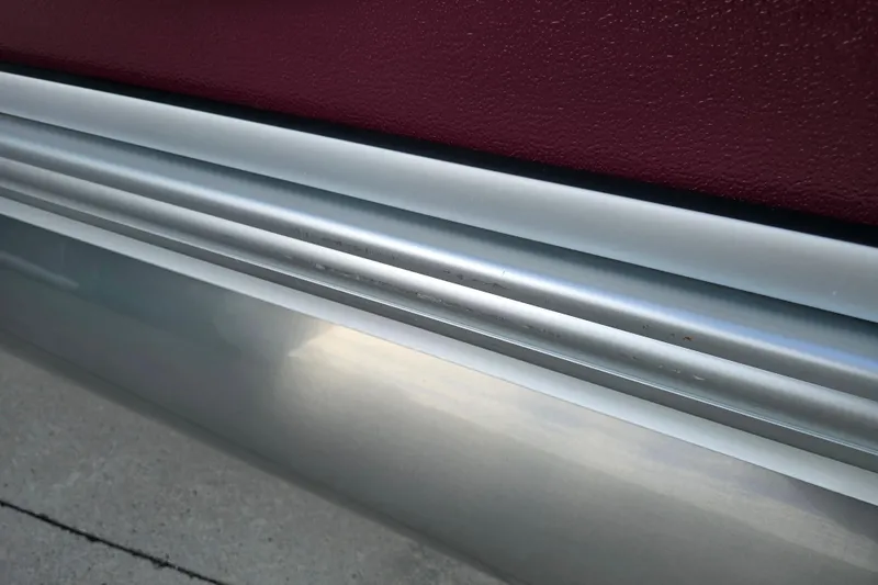 Slide: The Image of Close-up of a 2017 Premier 220 SunSation pontoon boat's aluminum side detail. - 11