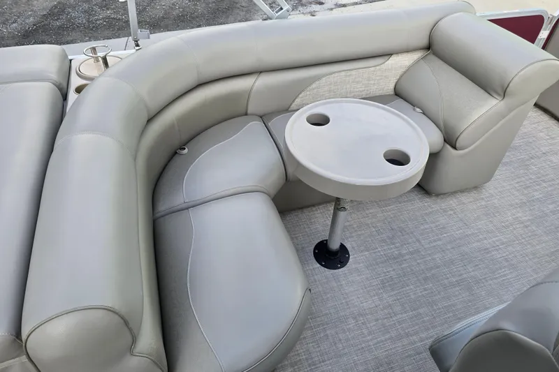 Slide: The Image of 2017 Premier 220 SunSation boat interior with beige seating and privacy curtain. - 17