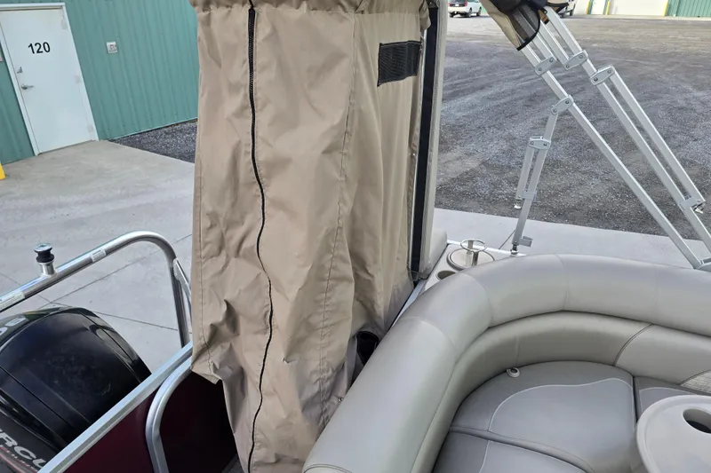 Slide: The Image of 2017 Premier 220 SunSation boat helm with steering wheel, gauges, and captain's chair. - 18