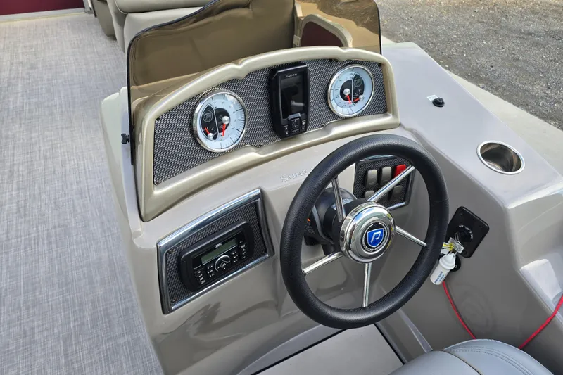 Slide: The Image of Captain's chair and controls of a 2017 Premier 220 SunSation boat, featuring sleek design and comfort. - 20