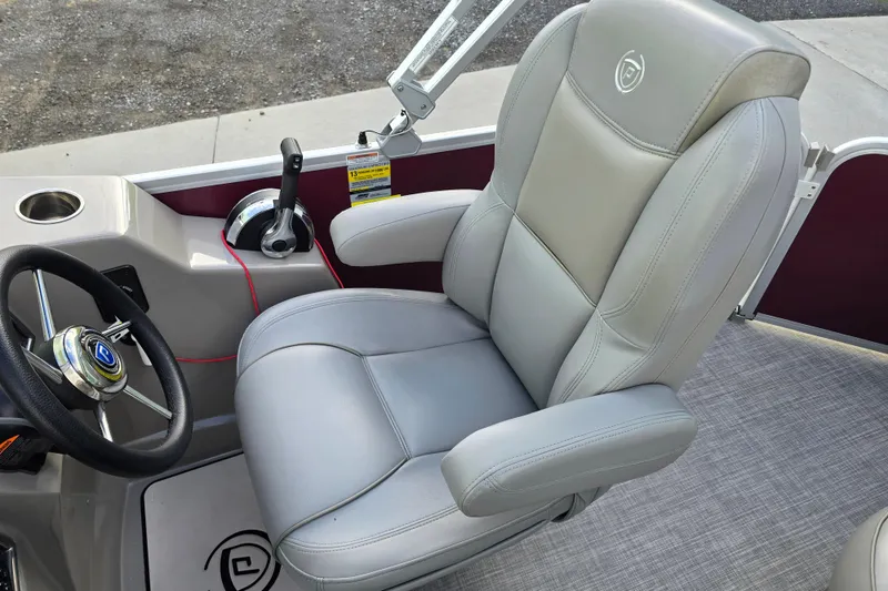 Slide: The Image of 2017 Premier 220 SunSation pontoon boat interior with gray seating and red fenders. - 21