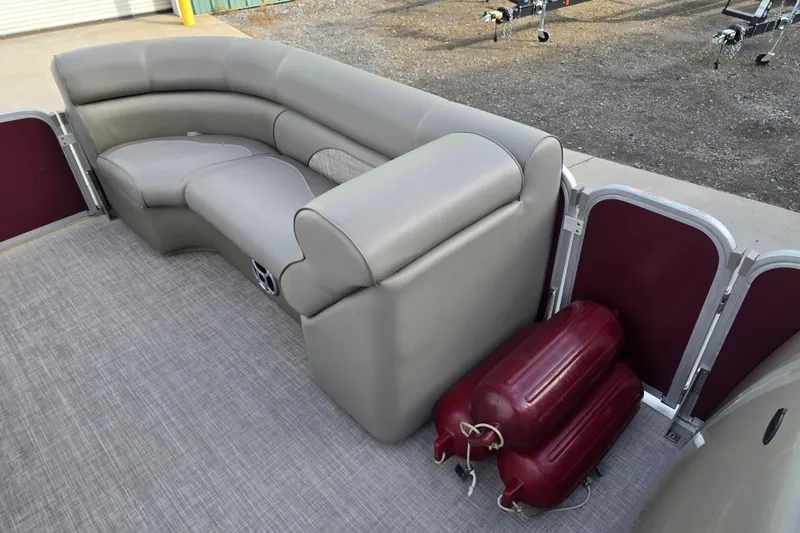 Slide: The Image of 2017 Premier 220 SunSation pontoon boat with gray cushioned seating and textured flooring. - 22