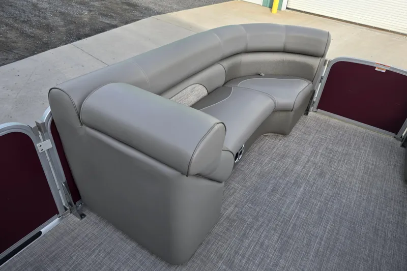 Slide: The Image of 2017 Premier 220 SunSation pontoon boat with spacious gray seating and carpeted deck. - 24