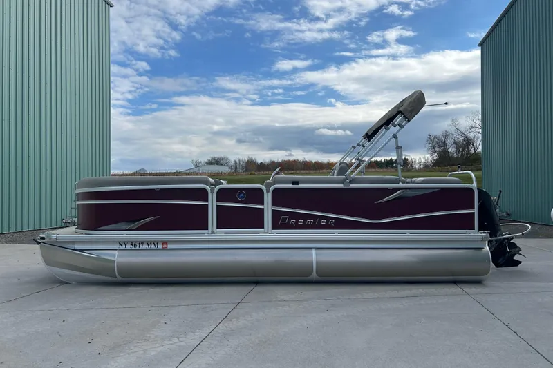 Slide: The Image of Close-up of a 2017 Premier 220 SunSation boat motor with protective metal guard. - 35