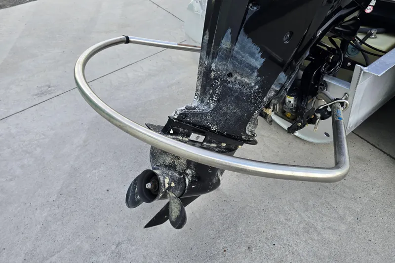 Slide: The Image of 2017 Premier 220 SunSation pontoon boat with maroon exterior, parked near green buildings. - 5