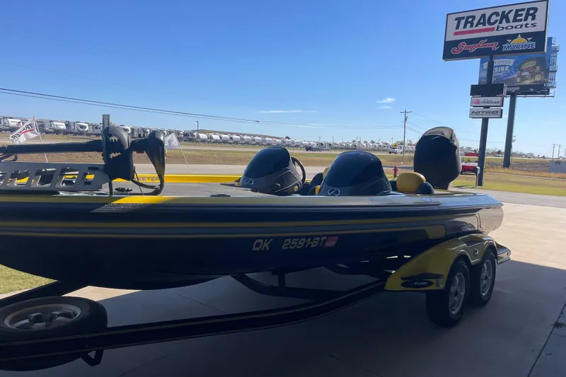 Slide: The Image of 2008 Skeeter 20i boat parked at Tracker Boats dealership under clear blue sky. - 2