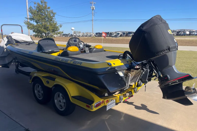 Slide: The Image of 2008 Skeeter 20i boat with dual console and outboard motor on trailer. - 3