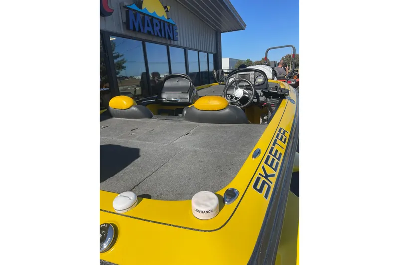 Slide: The Image of 2008 Skeeter 20i yellow boat with steering wheel, seats, and marine equipment. - 6