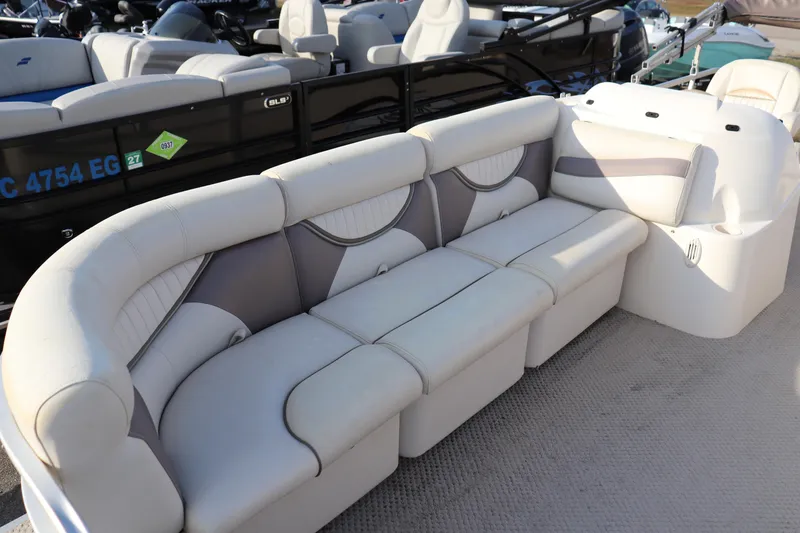 Slide: The Image of 2008 Sweetwater 2186RE boat interior with white and gray seating arrangement. - 2