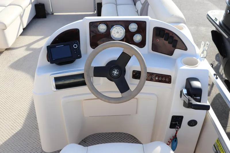 Slide: The Image of 2008 Sweetwater 2186RE boat dashboard with steering wheel, gauges, and controls. - 5