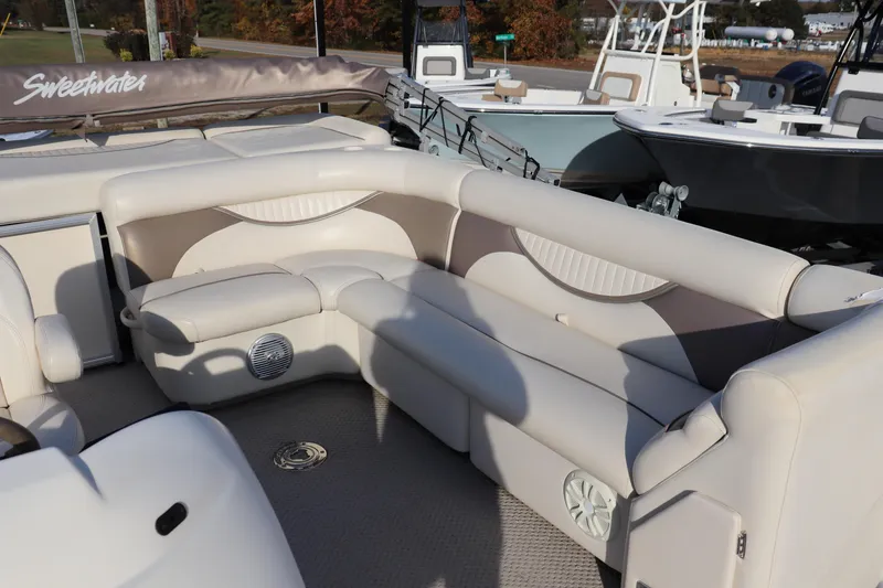 Slide: The Image of 2008 Sweetwater 2186RE boat interior with beige seating and speaker. - 6