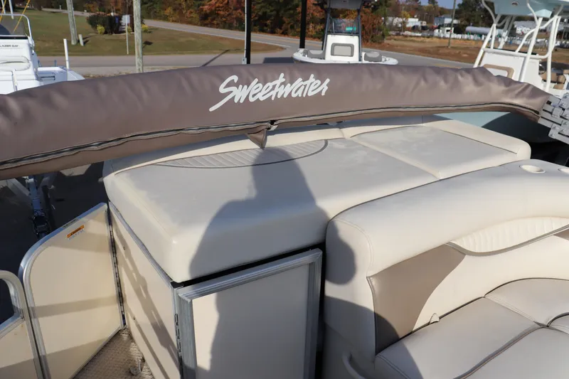 Slide: The Image of 2008 Sweetwater 2186RE boat interior with cushioned seating and protective cover. - 7