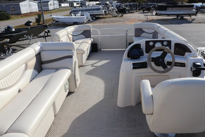 Slide: The Image of Interior of a 2008 Sweetwater 2186RE pontoon boat with beige seating and steering console. - 8