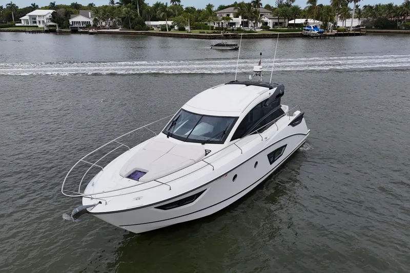 Slide: The Image of 2018 Beneteau Gran Turismo 50 yacht cruising on a scenic waterway. - 11