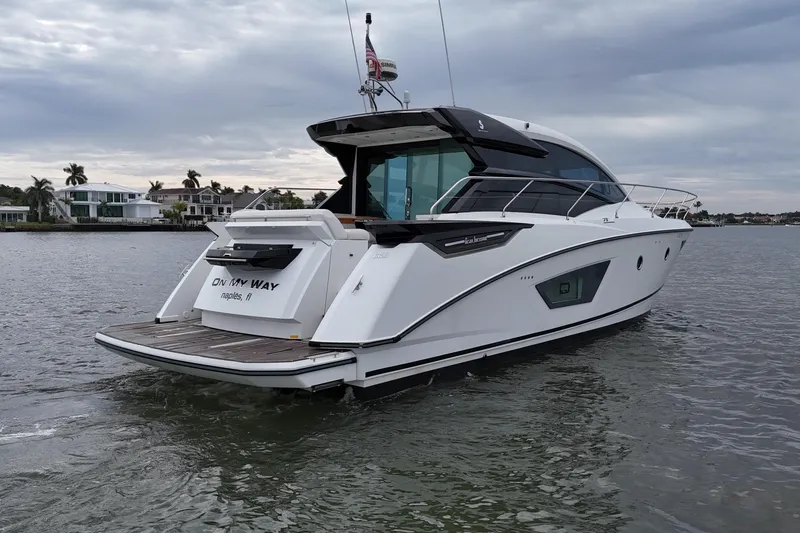 Slide: The Image of 2018 Beneteau Gran Turismo 50 yacht on water, rear view, overcast sky. - 18