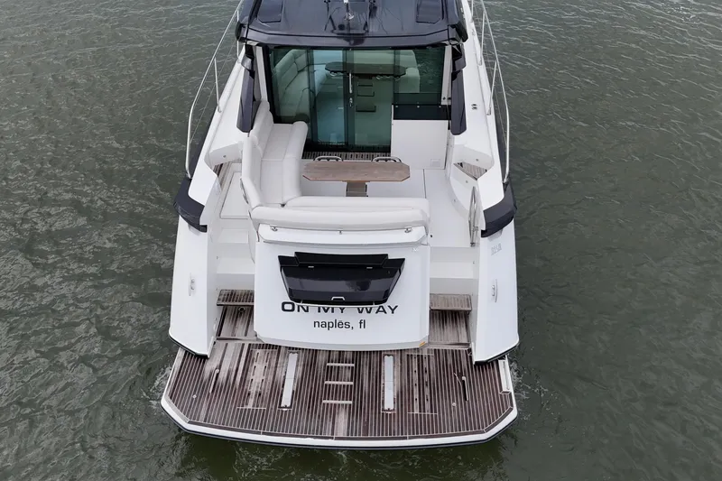 Slide: The Image of 2018 Beneteau Gran Turismo 50 yacht, rear view, docked in water, Naples, FL. - 22