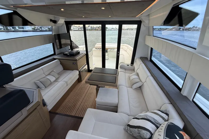 Slide: The Image of Luxurious interior of 2018 Beneteau Gran Turismo 50 yacht with panoramic windows and plush seating. - 23