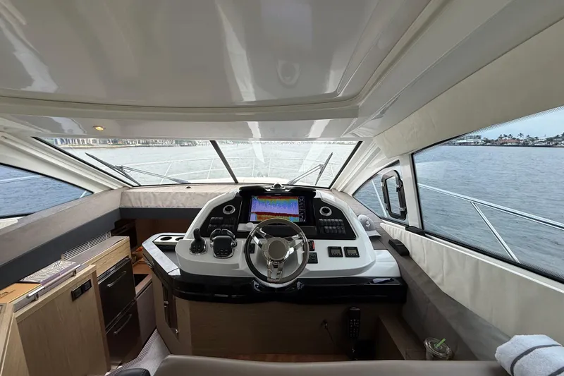 Slide: The Image of 2018 Beneteau Gran Turismo 50 yacht cockpit with modern navigation controls and panoramic view. - 27