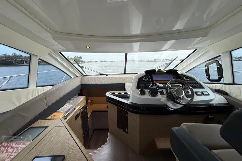 Slide: The Image of 2018 Beneteau Gran Turismo 50 yacht interior with modern helm and panoramic windows. - 28