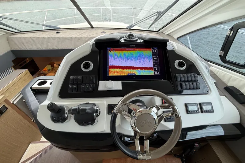 Slide: The Image of 2018 Beneteau Gran Turismo 50 helm with advanced navigation display and controls. - 30