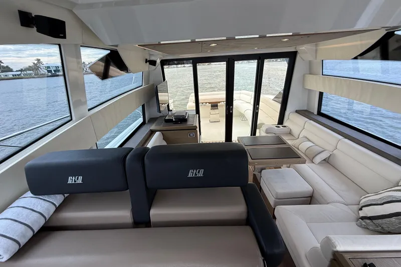 Slide: The Image of Luxurious interior of 2018 Beneteau Gran Turismo 50 yacht with panoramic windows and plush seating. - 32