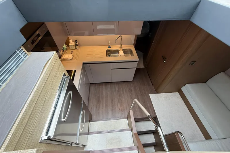 Slide: The Image of Modern kitchen interior of 2018 Beneteau Gran Turismo 50 yacht, featuring sleek cabinetry and appliances. - 34