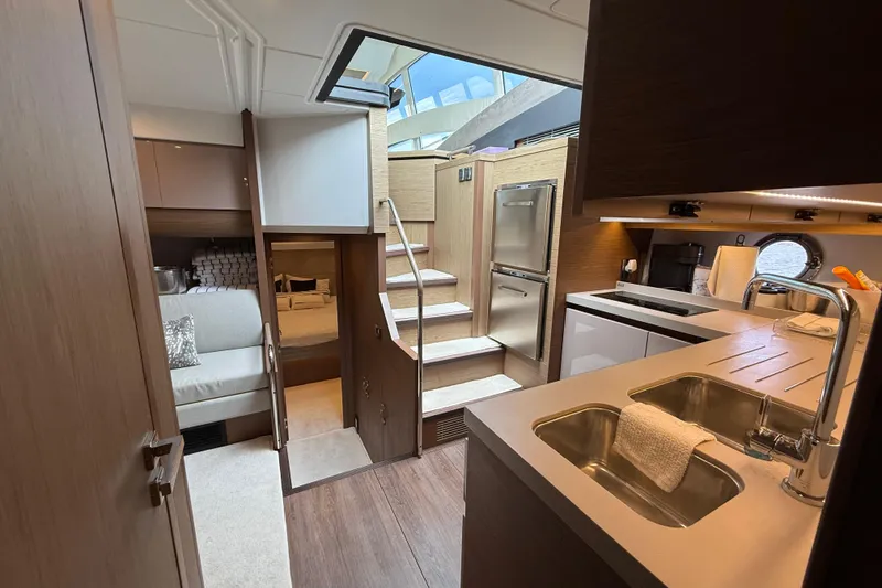 Slide: The Image of Luxurious interior of 2018 Beneteau Gran Turismo 50 yacht with modern kitchen and cozy seating area. - 40