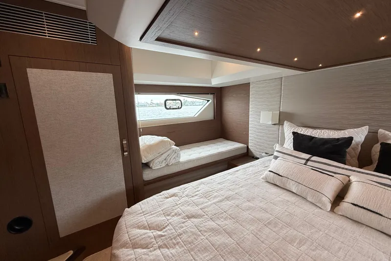 Slide: The Image of Luxurious 2018 Beneteau Gran Turismo 50 yacht bedroom with elegant bedding and window view. - 46