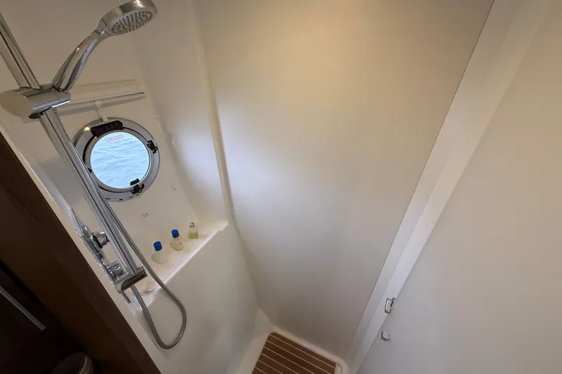 Slide: The Image of Shower area in 2018 Beneteau Gran Turismo 50 yacht with porthole and modern fixtures. - 54