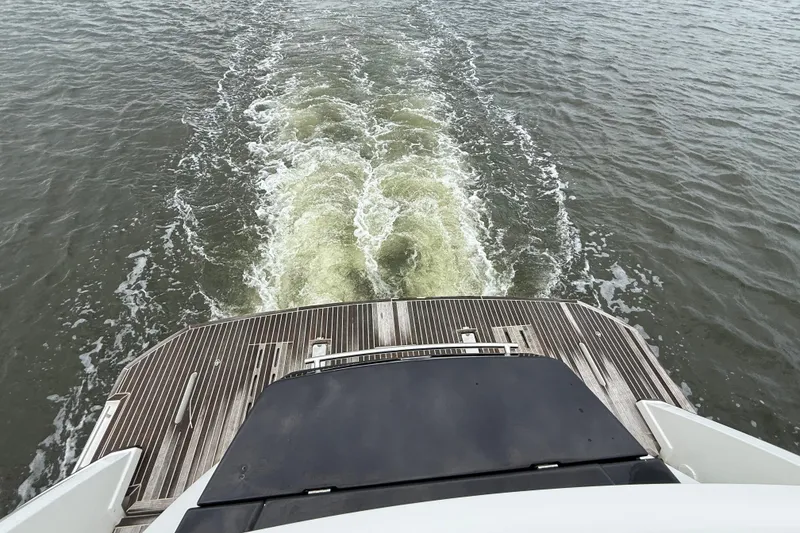 Slide: The Image of Stern view of 2018 Beneteau Gran Turismo 50 yacht cruising on open water. - 56