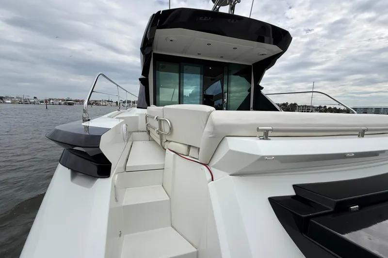 Slide: The Image of 2018 Beneteau Gran Turismo 50 yacht, sleek design, docked on a cloudy day. - 57
