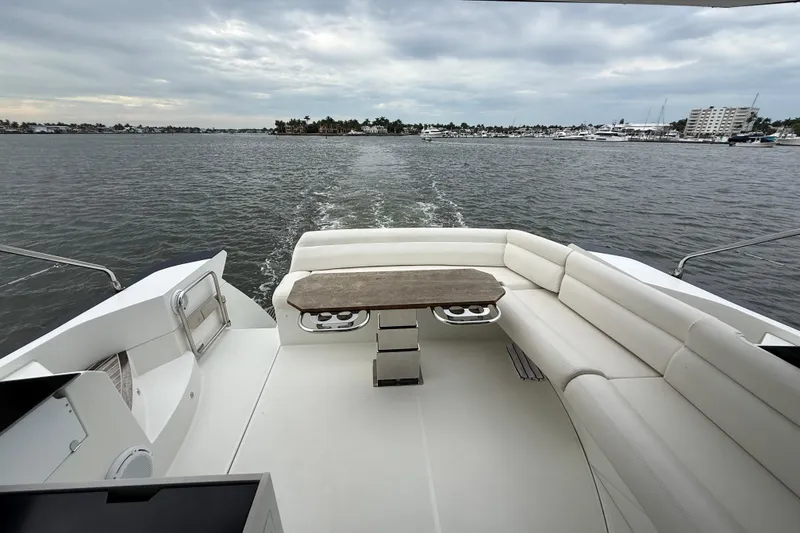 Slide: The Image of 2018 Beneteau Gran Turismo 50 yacht with spacious deck and seating, cruising on open water. - 58