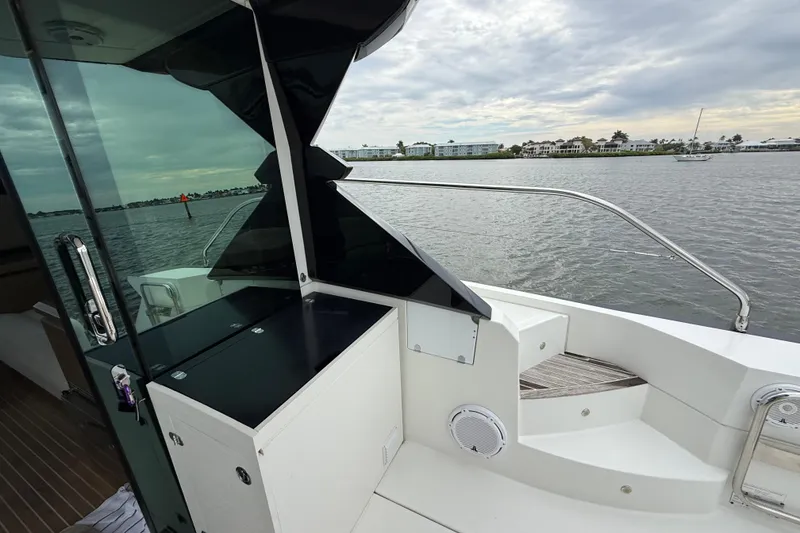 Slide: The Image of 2018 Beneteau Gran Turismo 50 yacht deck with scenic waterfront view. - 60