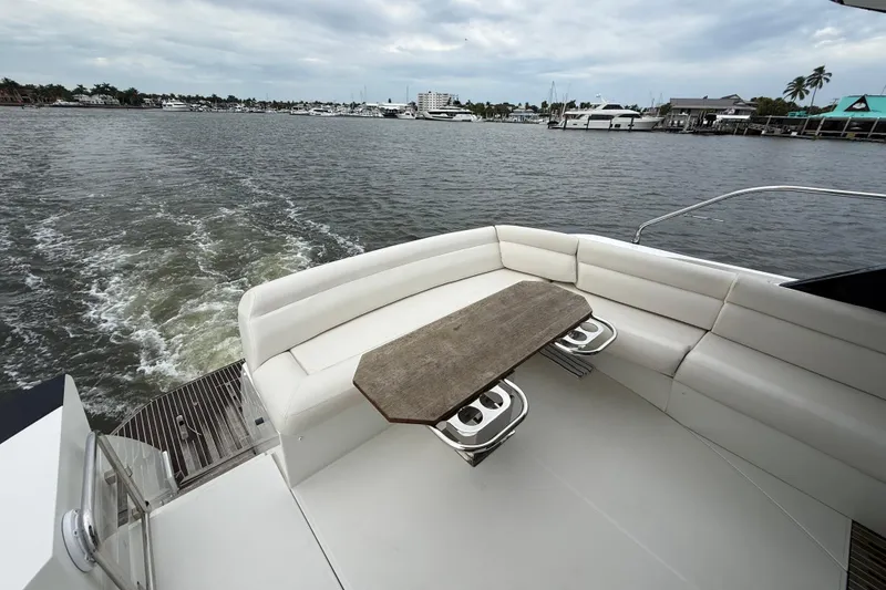 Slide: The Image of 2018 Beneteau Gran Turismo 50 yacht with elegant seating and scenic water view. - 61