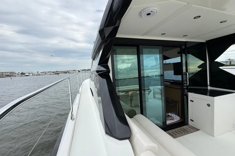 Slide: The Image of 2018 Beneteau Gran Turismo 50 yacht with sleek design, docked by the water. - 65