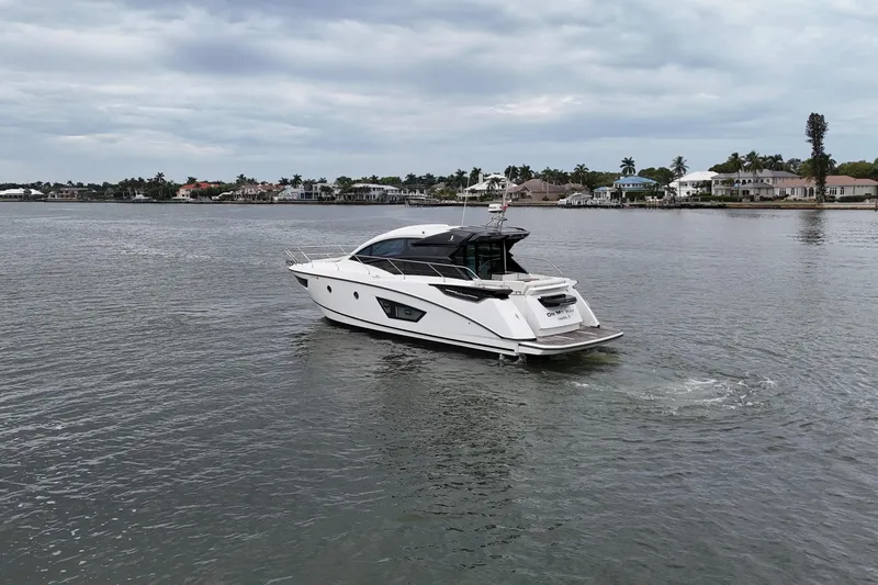 Slide: The Image of 2018 Beneteau Gran Turismo 50 yacht cruising on a calm waterway. - 77