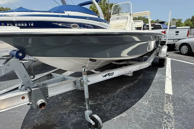 Slide: The Image of 2023 Mako 18 LTS boat on trailer in parking lot, side view. - 1