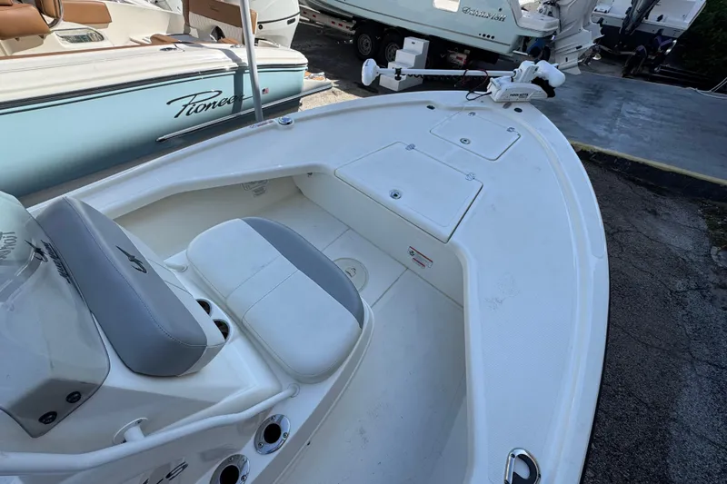 Slide: The Image of 2023 Mako 18 LTS boat interior with seating and storage compartments. - 11