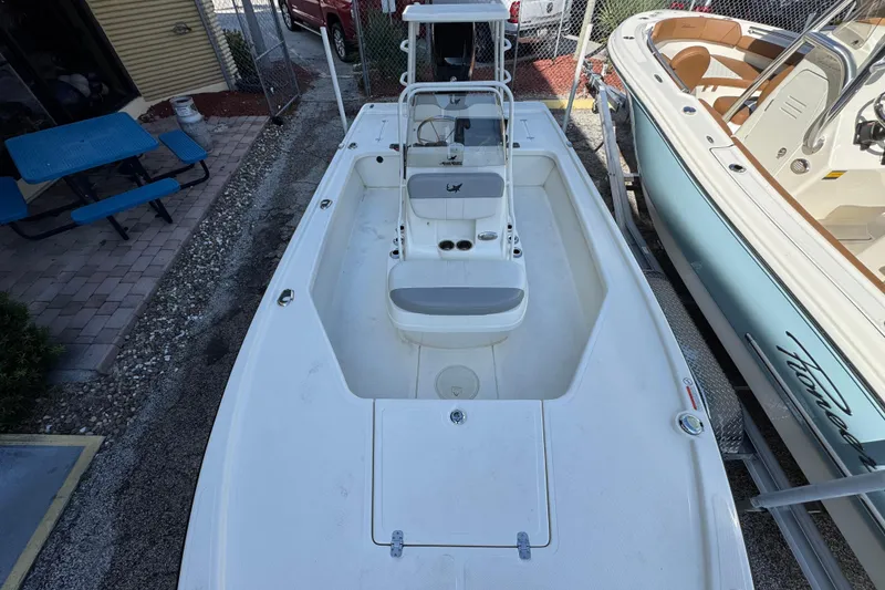 Slide: The Image of 2023 Mako 18 LTS boat, white interior, parked outdoors, top view. - 14