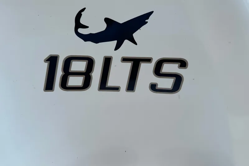 Slide: The Image of 2023 Mako 18 LTS logo with shark silhouette on white background. - 20
