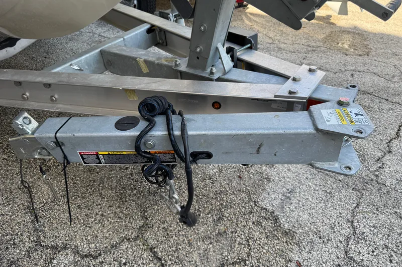 Slide: The Image of Trailer hitch of a 2023 Mako 18 LTS boat on a paved surface. - 5