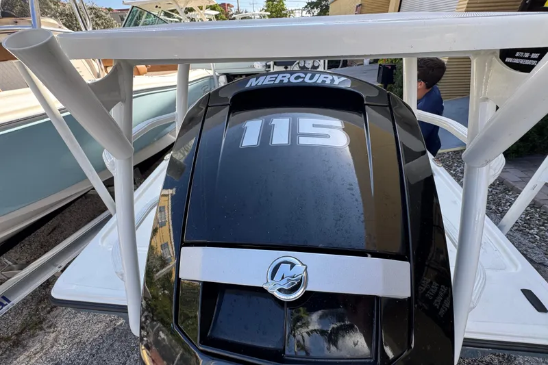 Slide: The Image of 2023 Mako 18 LTS boat with Mercury 115 outboard engine, parked outdoors. - 8