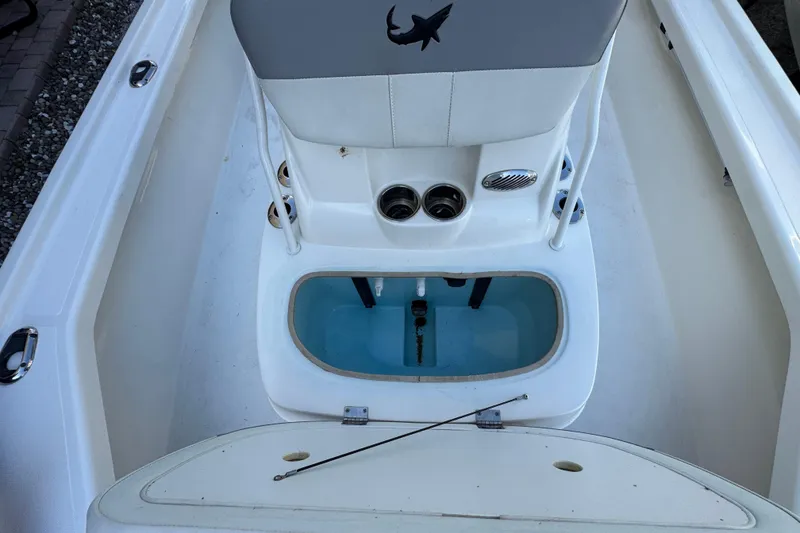 Slide: The Image of 2023 Mako 18 LTS boat interior with livewell and seating area. - 9