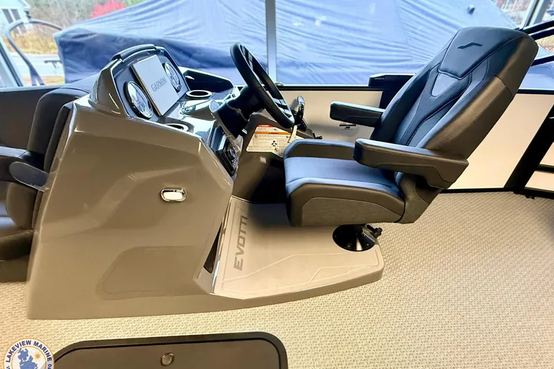 Slide: The Image of Captain's chair and control console of 2026 Evotti 523CS boat, featuring modern design. - 12