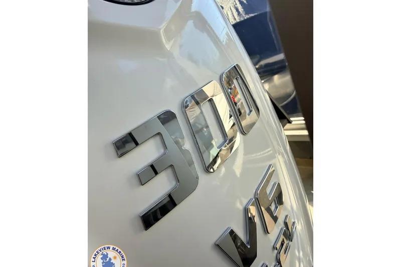 Slide: The Image of Close-up of 2026 Evotti 523CS engine badge, featuring chrome '300 V6' lettering. - 3