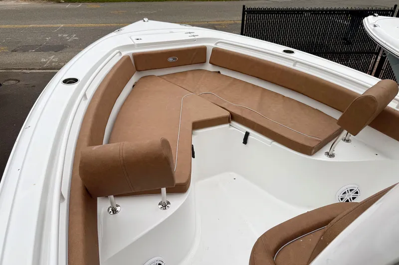 Slide: The Image of 2026 Sea Hunt Ultra 245 SE boat interior with tan cushioned seating. - 10