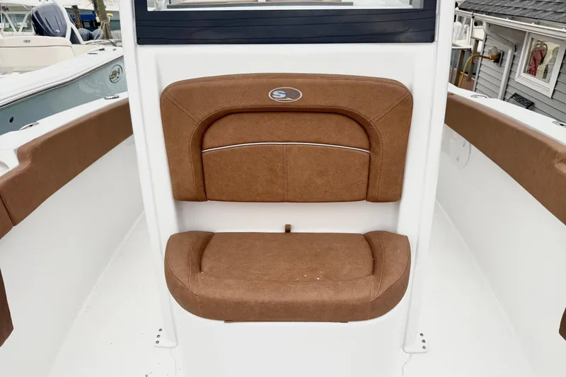 Slide: The Image of 2026 Sea Hunt Ultra 245 SE boat seat with brown upholstery. - 11