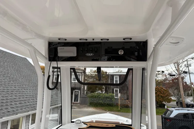 Slide: The Image of 2026 Sea Hunt Ultra 245 SE boat interior with control panel and Garmin device. - 15